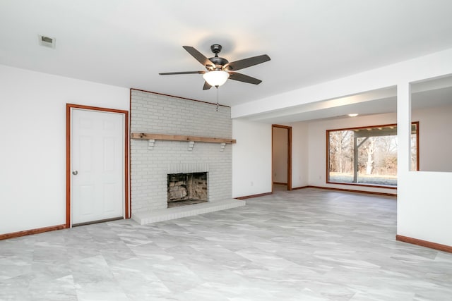 unfurnished living room featuring a brick fireplace, visible vents, baseboards, and ceiling fan