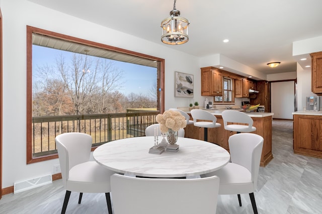 dining space with recessed lighting, visible vents, baseboards, and an inviting chandelier