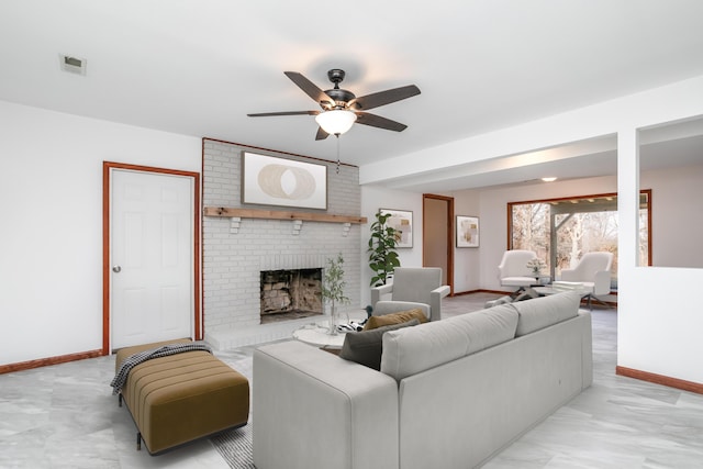 living area featuring visible vents, a fireplace, baseboards, and ceiling fan