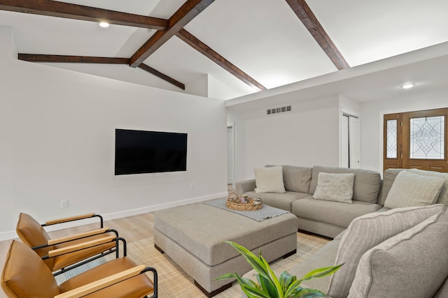 living area featuring visible vents, baseboards, lofted ceiling with beams, light wood-style flooring, and recessed lighting