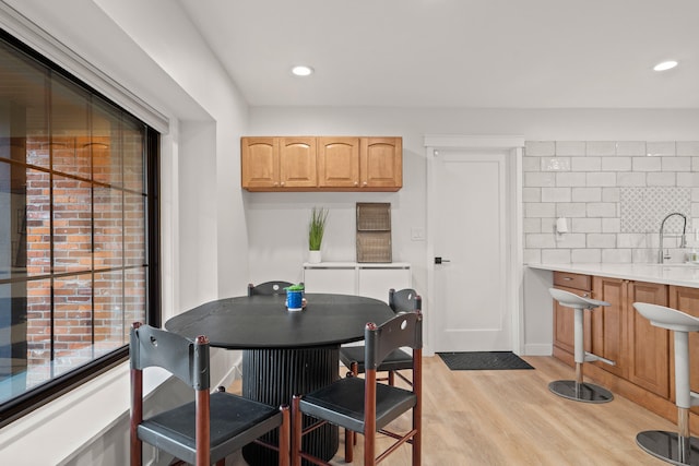 dining room featuring light wood-type flooring and recessed lighting