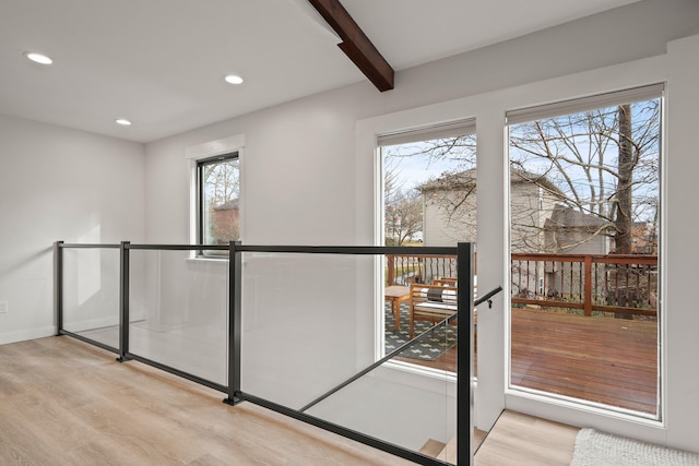 doorway to outside with baseboards, wood finished floors, beam ceiling, and recessed lighting