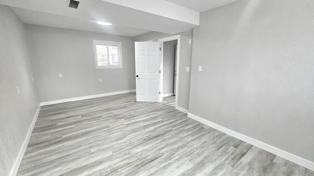 basement with light hardwood / wood-style flooring