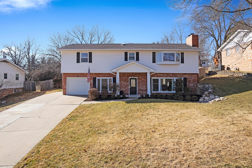 view of front of home featuring a garage and a front lawn