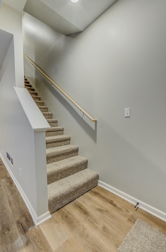 stairway with wood-type flooring