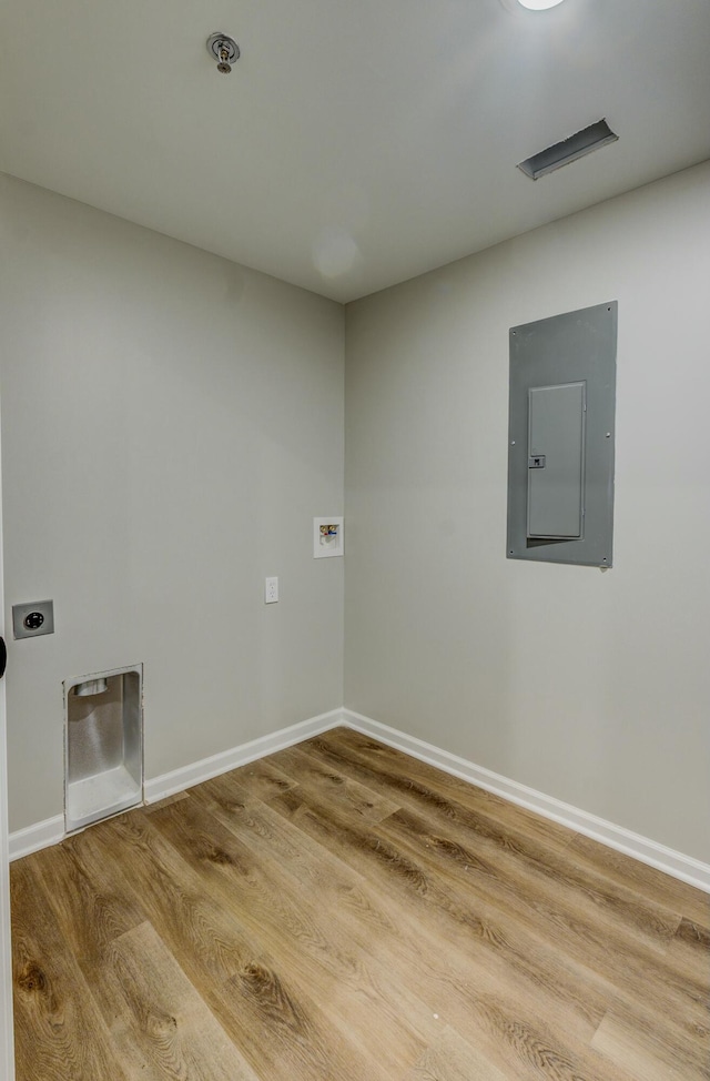 spare room featuring wood-type flooring and electric panel