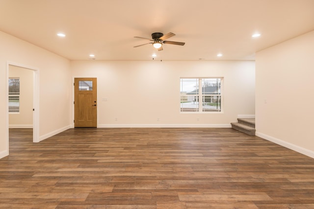 interior space with ceiling fan and dark hardwood / wood-style floors