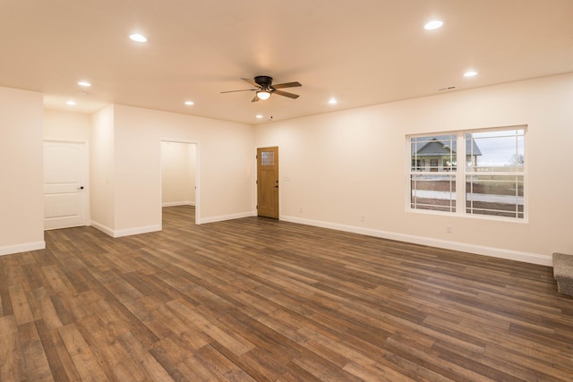 spare room with ceiling fan and dark hardwood / wood-style flooring