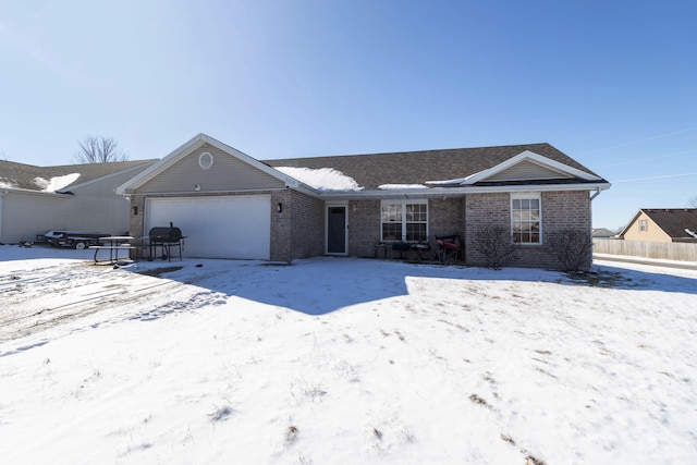 ranch-style house with a garage, fence, and brick siding