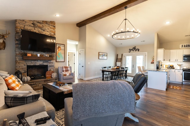 living room featuring high vaulted ceiling, a fireplace, dark hardwood / wood-style flooring, french doors, and beamed ceiling