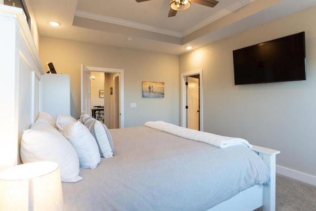 bedroom featuring crown molding, ceiling fan, a tray ceiling, and carpet