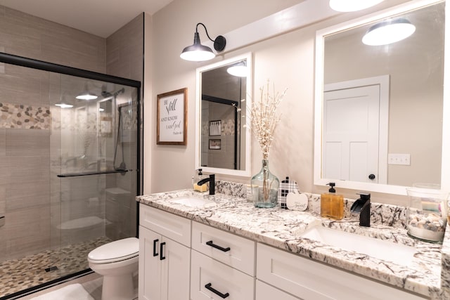 bathroom featuring walk in shower, vanity, and toilet