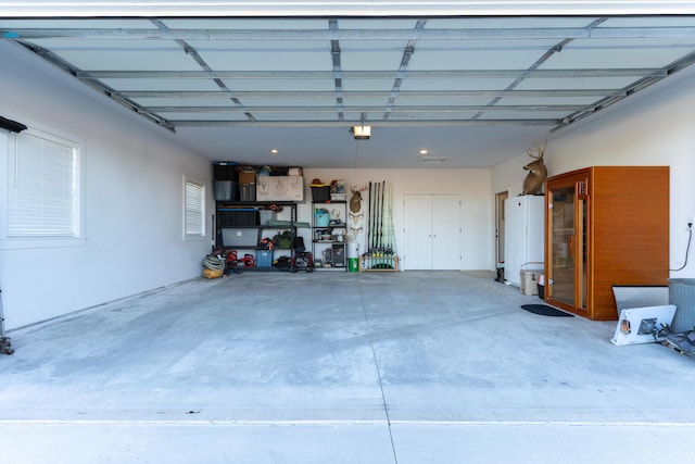 garage featuring a garage door opener and water heater