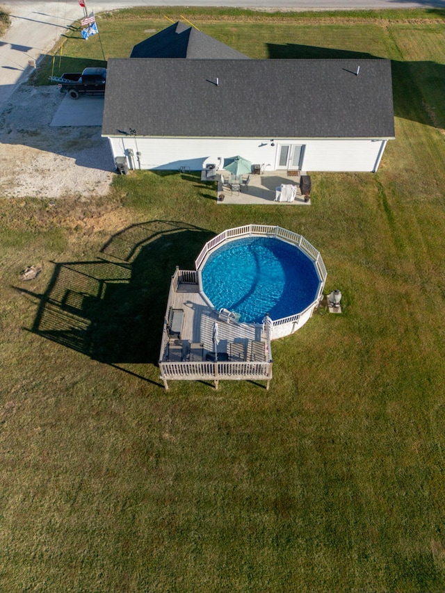 view of pool with a yard