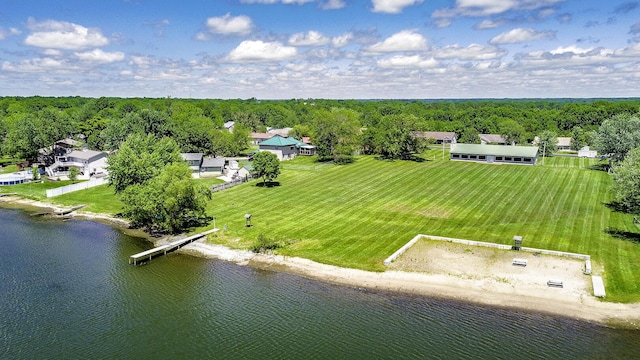 aerial view with a water view and a wooded view