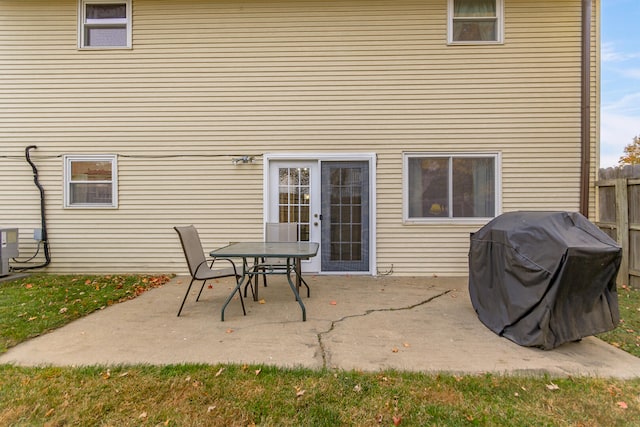 rear view of house with a patio and fence