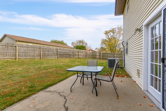 view of patio featuring outdoor dining space, a fenced backyard, and central air condition unit