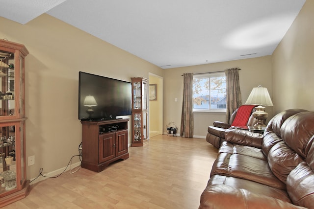 living area featuring light wood finished floors and baseboards