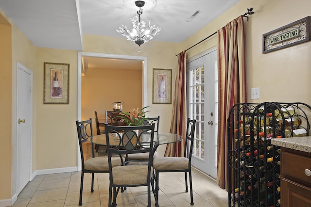 dining room featuring light tile patterned floors, baseboards, visible vents, an inviting chandelier, and french doors