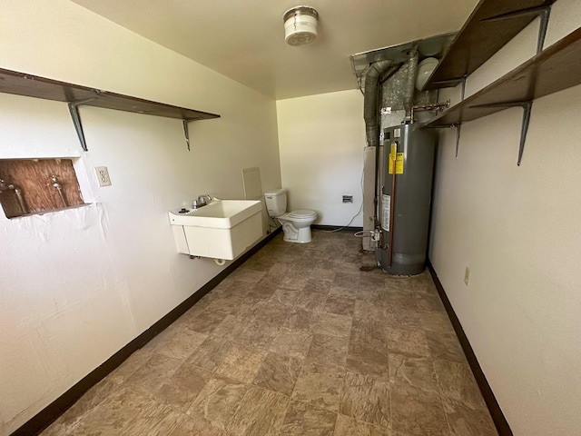 bathroom with toilet, sink, and gas water heater