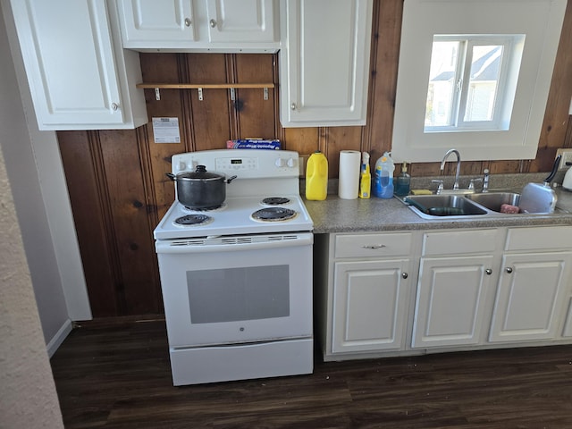 kitchen featuring electric stove, white cabinetry, dark wood-type flooring, and sink