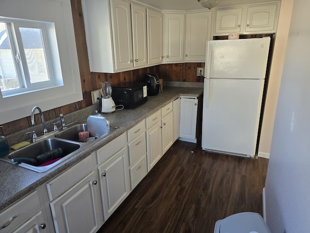 kitchen featuring white cabinetry, sink, dark hardwood / wood-style floors, and white refrigerator