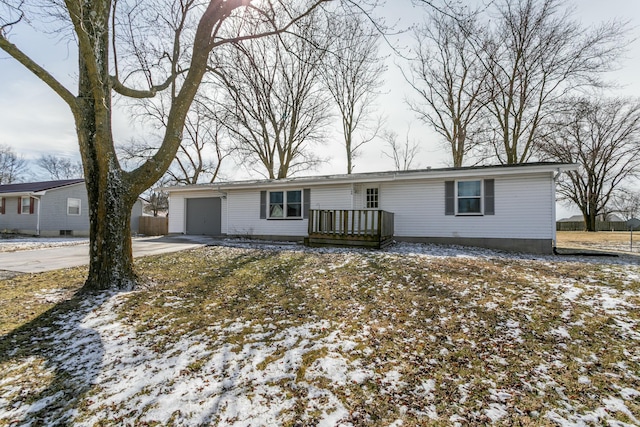 single story home featuring concrete driveway and an attached garage