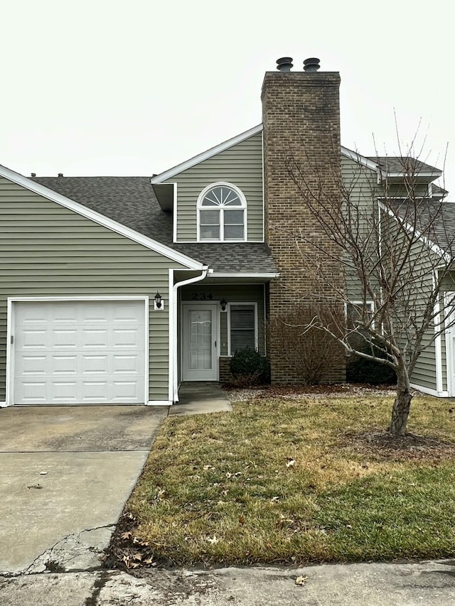 front facade with a garage and a front lawn