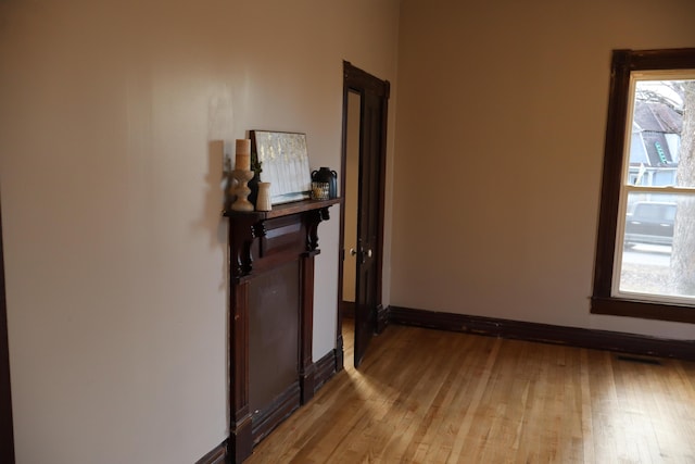 hallway with plenty of natural light and light hardwood / wood-style floors