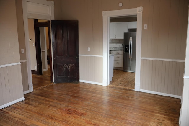 empty room featuring hardwood / wood-style floors and radiator