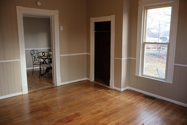 unfurnished room featuring hardwood / wood-style flooring