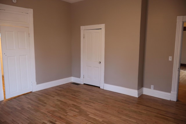 unfurnished bedroom with hardwood / wood-style flooring