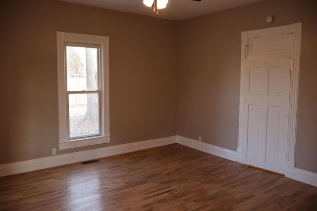 unfurnished room with dark hardwood / wood-style floors and ceiling fan