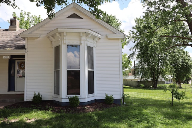 402 W Spring St, Fayette, MO 65248 - view of home's exterior featuring a chimney
