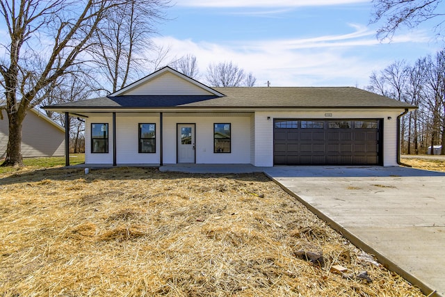 view of front of home with a porch, driveway, a garage, and roof with shingles