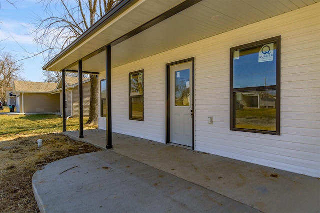 view of exterior entry featuring a patio