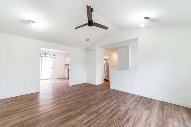 empty room featuring hardwood / wood-style flooring, vaulted ceiling, and ceiling fan