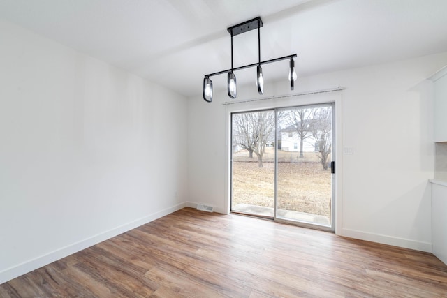 unfurnished dining area featuring light hardwood / wood-style flooring