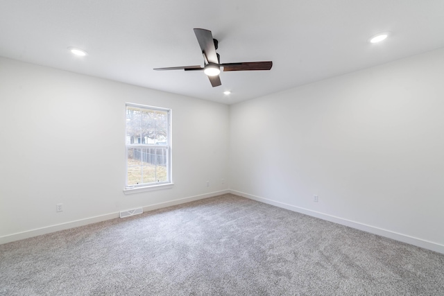 carpeted empty room featuring ceiling fan