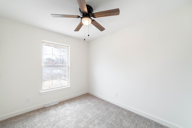 carpeted empty room featuring ceiling fan