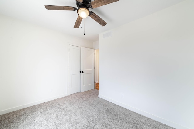 empty room featuring carpet flooring and ceiling fan