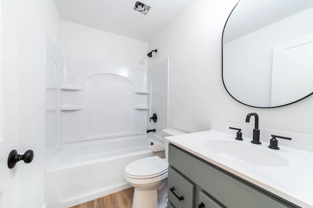 full bathroom featuring shower / bathing tub combination, vanity, hardwood / wood-style flooring, and toilet