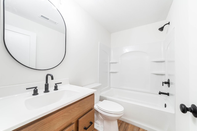 full bathroom with vanity, hardwood / wood-style flooring, toilet, and shower / bath combination