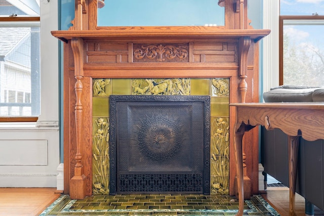 interior details featuring a tile fireplace