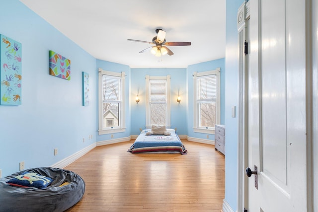 bedroom featuring light hardwood / wood-style floors and ceiling fan