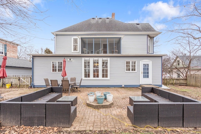 back of house featuring an outdoor living space and a patio area