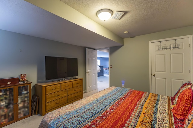 carpeted bedroom with a textured ceiling