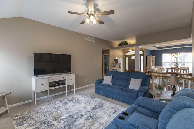 carpeted living room featuring vaulted ceiling, ceiling fan, and ornate columns