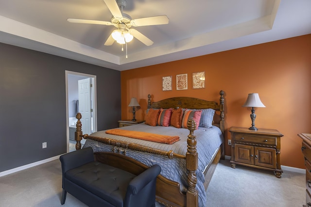 carpeted bedroom featuring ceiling fan and a raised ceiling