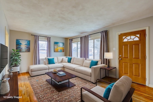 living room featuring a wealth of natural light and light hardwood / wood-style floors